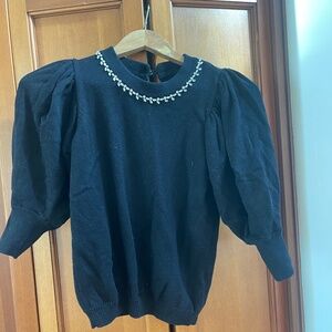 Bash top with jewelry detail at color and puff sleeves